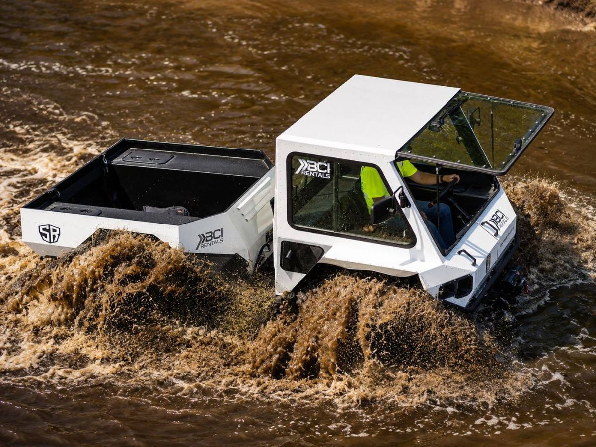 Swamp Rider amphibious UTV swimming through deep water on a flooded right-of-way